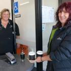 Claire Wilson, of Balclutha, picks up two cappuccinos from Heart & Soul Cafe owner Robyn Bell...