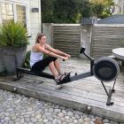 Gina Crampton on the rowing machine at her Wellington base. PHOTO SUPPLIED
