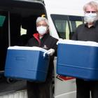 Whitestone Taxis drivers Shige Koyama (left) and Garry Meynell load up with the day’s Meals on...