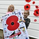 Maleika (5) and Lockie (3) Tuliau hold the Otago Daily Times poppy in front of their own handmade...