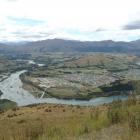 The Shotover River, with the expanding Shotover Country subdivision, at right. Photo by David...