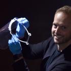 Damien van Brandenburg, of Architecture Van Brandenburg, holds one of the masks he made on a 3-D...