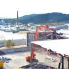 A digger brings down part of the former Cadbury warehouse in Dunedin yesterday, as work picks up...