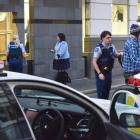 A man is led away after the front door of the Dunedin courthouse in Dunbar St was smashed...