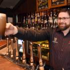 Bruce Hoffman, duty manager at Craic in the Octagon, pours a beer yesterday. PHOTO: PETER MCINTOSH
