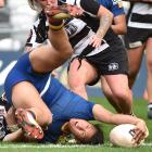 Otago Spirit second five-eighth Kilisitina Moata'ane places the ball to score as Hawke's Bay No8...