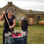 Lou Farrand washes her clothing in a copper boiler at her historic cottage near Roxburgh. She has...