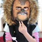 Scarlet Milner, of Dunedin, uses one hand to keep her Chewbacca mask in place while doing her...