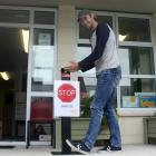 Maheno School principal Ryan Fraser tries out the foot-operated dispenser made by Oamaru’s Anvil...