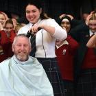 Kaikorai Valley College principal Rick Geerlofs is given a much-needed haircut by head girl...