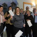 Invercargill lawyer Liz Henry (centre) distributed vouchers to her staff, to be spent in local...