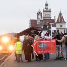 Dunedin Railways Limited workers and supporters farewell a passenger train leaving for the North...