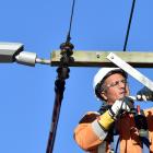 Installing a new LED street light in Stevenson Rd, Concord, yesterday, is Broadspectrum employee...