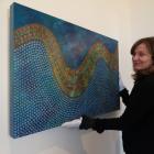 Colourful . . . Forrester Gallery director Jane Macknight prepares to hang a piece by Samoan...