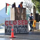 A police officer speaks to protesters at the Ravensdown fertiliser plant in Dunedin yesterday....