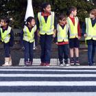Easily spotted while crossing the road in their hi-vis vests are Musselburgh School pupils (from...