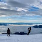 Early snowboarders and skiers take to Treble Cone's Triple Treat slopes on the opening day on...