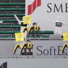 Robots cheer the team next to empty spectator seats at a baseball game between SoftBank Hawks and...