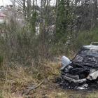 A car was found well ablaze in bush near Caversham Valley Rd yesterday. PHOTO: STEPHEN JAQUIERY
