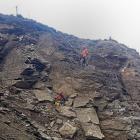 Abseilers work on a large slip near Cromwell yesterday above State Highway 8. PHOTO: SUPPLIED
