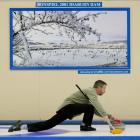 Kenny Thomson glides past a photograph of the 2001 Bonspiel  at Idaburn during the national...