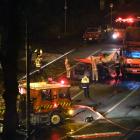 Firefighters assist at the scene of a double fatality crash between a car and a truck near a...