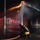 Firefighters tackle a blaze at the old Wolfenden and Russell building in South Dunedin on...