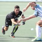 Black Sticks defender Kane Russell competes for the ball with an Argentina player during a men’s...