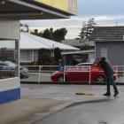 A police photographer documents evidence at the scene. PHOTOS: ABBEY PALMER