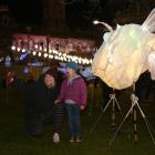 Naomi Daniels and daughter Elizabeth (4) pose for a selfie with a giant anglerfish lantern at the...
