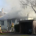 Smoke billows from a house fire in Middleton Rd, Dunedin. Photo: Gerard O'Brien