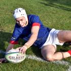 St Kevin’s wing Christian Bailee dots down for a try in the corner during his side’s win over...