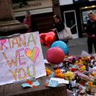 People look at flowers for the victims of the Manchester Arena attack. Photo: Reuters