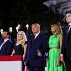 President Donald Trump gives a thumbs-ups next to first lady Melania Trump and their extended...