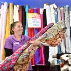 Lincraft sales assistant Erin Boock holds fabric, a hot commodity among shoppers at present....