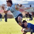King’s High player Joji Buli is tackled by Southland Boys’ Gareth Turnock during their Otago...