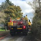 A rural Fire and Emergency New Zealand crew at the scene of the house fire near Waikouaiti. Photo...