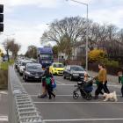 Pedestrians on SH76/Brougham St using a crossing near Addington School. Photo: Geoff Sloan