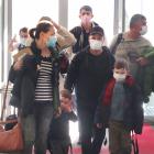 Travellers on a flight from Auckland arrive at Queenstown Airport yesterday. PHOTO: HUGH COLLINS

