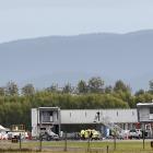 A Bombardier Global Express jet sits on the runway at an otherwise all but abandoned Dunedin...