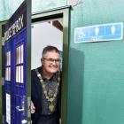 Dunedin Mayor Dave Cull peeks out of "the Turdis", Waitati's new public toilet, following a...