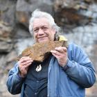 Harry Albert holds a piece of pillow lava found in the rock formations below First Church. He is...