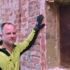 Highland Homes foreman Kyle Pomeroy with some interesting prints found in the wall of the old...