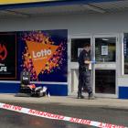 A police officer examining the scene in Invercargill today. Photo: Abbey Palmer