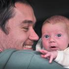 Father Jacob McSweeny, cradling 2-week-old daughter Lorea, says it could be hormones that have...