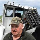 Jim Murdoch, of Milton, with his boat which capsized on the Taieri Mouth bar earlier this month....