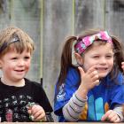 St Kilda Kindergarten teacher Jess Anderson uses sign language to communicate with (from left)...