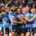James Tedesco celebrates a try with New South Wales team mates during their win last night in the...