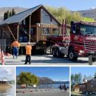 The Wanaka lakefront log cabin is moved on the back of a truck from its previous lakefront site ...