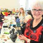 Tutor Jan Letts displays some of the brooches that were made out of recycled coffee pods during...